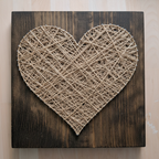 String art heart with natural twine on rustic wooden board