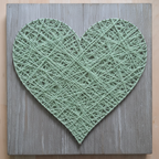 String art heart with sage yarn on cool weathered grey wooden board